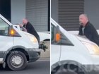 Road rage horror as man dangles from moving van.