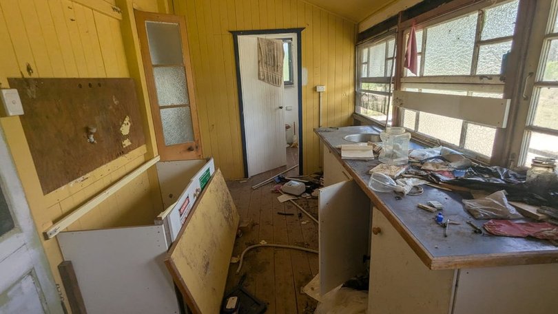 The two-bedroom home left in derelict condition with clutter and debris throughout.