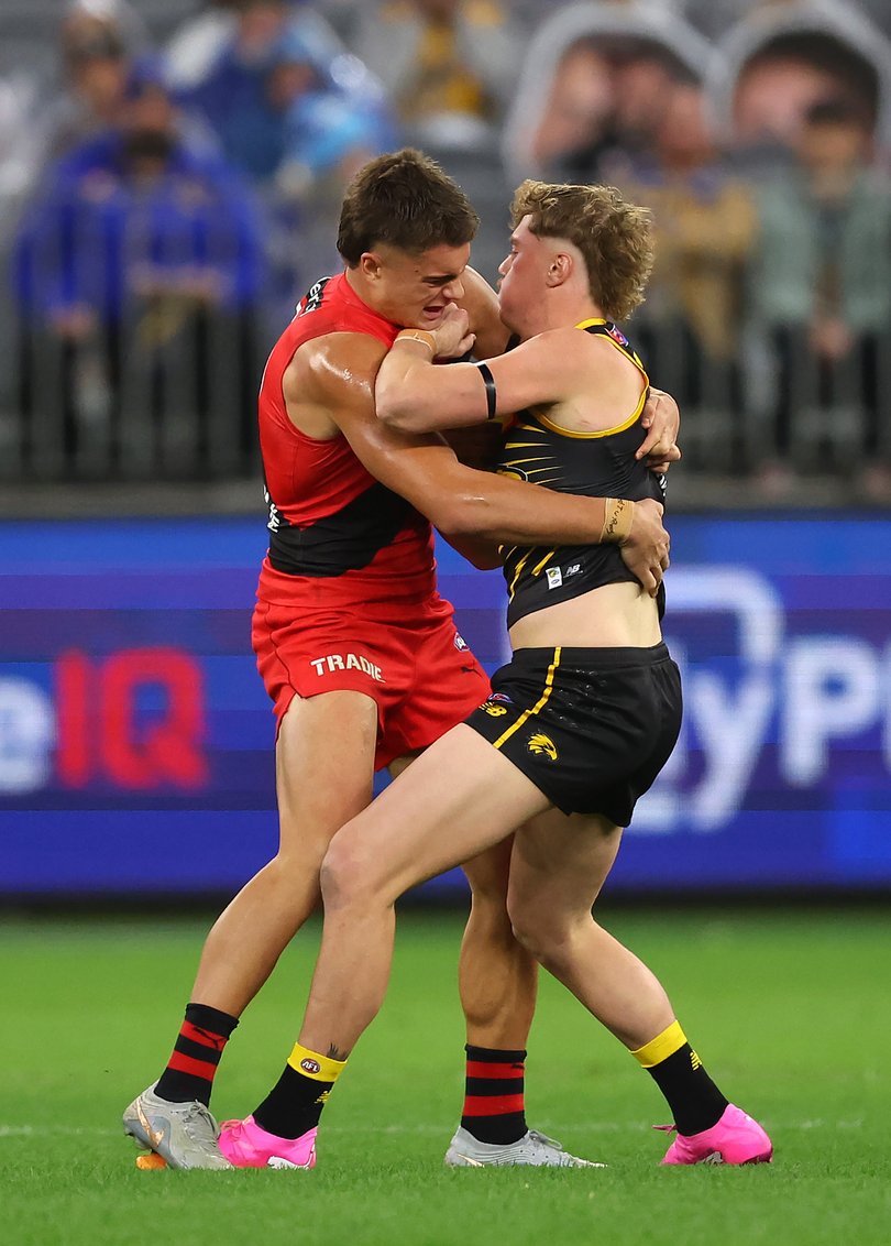 West Coast’s Harley Reid tries to get rid of Essendon’s Sullivan Robey.