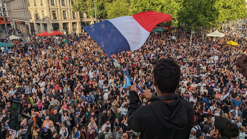 People gather to celebrate after the second round of the elections in Paris.