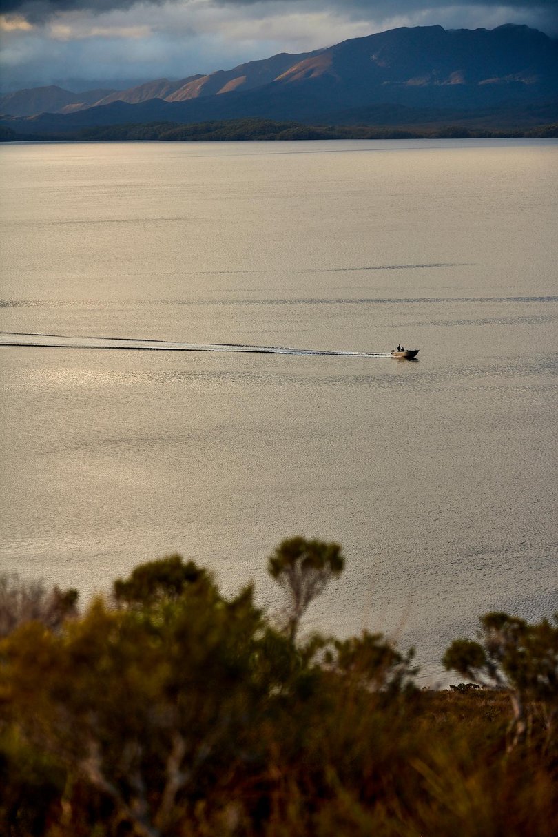 An adventure boat in the expansive waterway of Bathurst Harbour and Port Davey.
