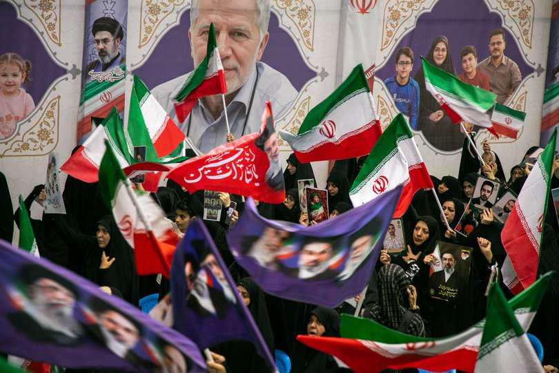 People hold portraits of the dead at the Imam Khomeini Mosalla Mosque to commemorate those killed in the current US-Israeli war on May 24, 2026 in Tehran, Iran.