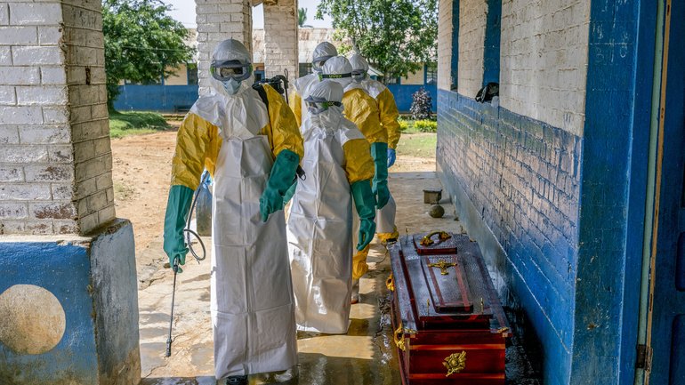 Health workers disinfect a coffin containing the body of a man presumed to have died of Ebola at a hospital in Mongbwalu, Democratic Republic of Congo, May 25, 2026. 