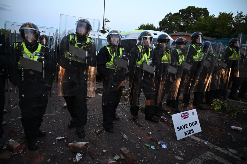  A sign which reads 'Save our kids' is displayed on the ground in front of riot police as protesters gather near the location where Henry Nowak died during a demonstration over the Police's handling of the incident, on June 2, 2026 in Southampton, England.