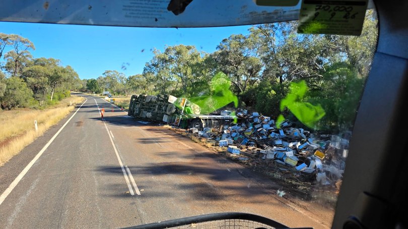 A truck carrying hundreds of bee hives has rolled over on a Queensland highway.