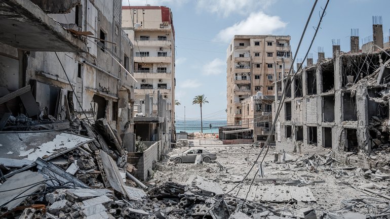 A lone palm tree remains stands amid the rubble in the Lebanese city of Tyre following an Israeli strike on June 2.