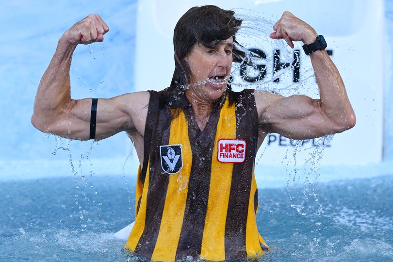 MELBOURNE, AUSTRALIA - JUNE 08: Mark Howard goes down the slide as Jason Dunstall for FightMND Big Freeze 12 ahead of the round 13 AFL match between Collingwood Magpies and Melbourne Demons at Melbourne Cricket Ground, on June 08, 2026, in Melbourne, Australia. (Photo by Quinn Rooney/Getty Images)