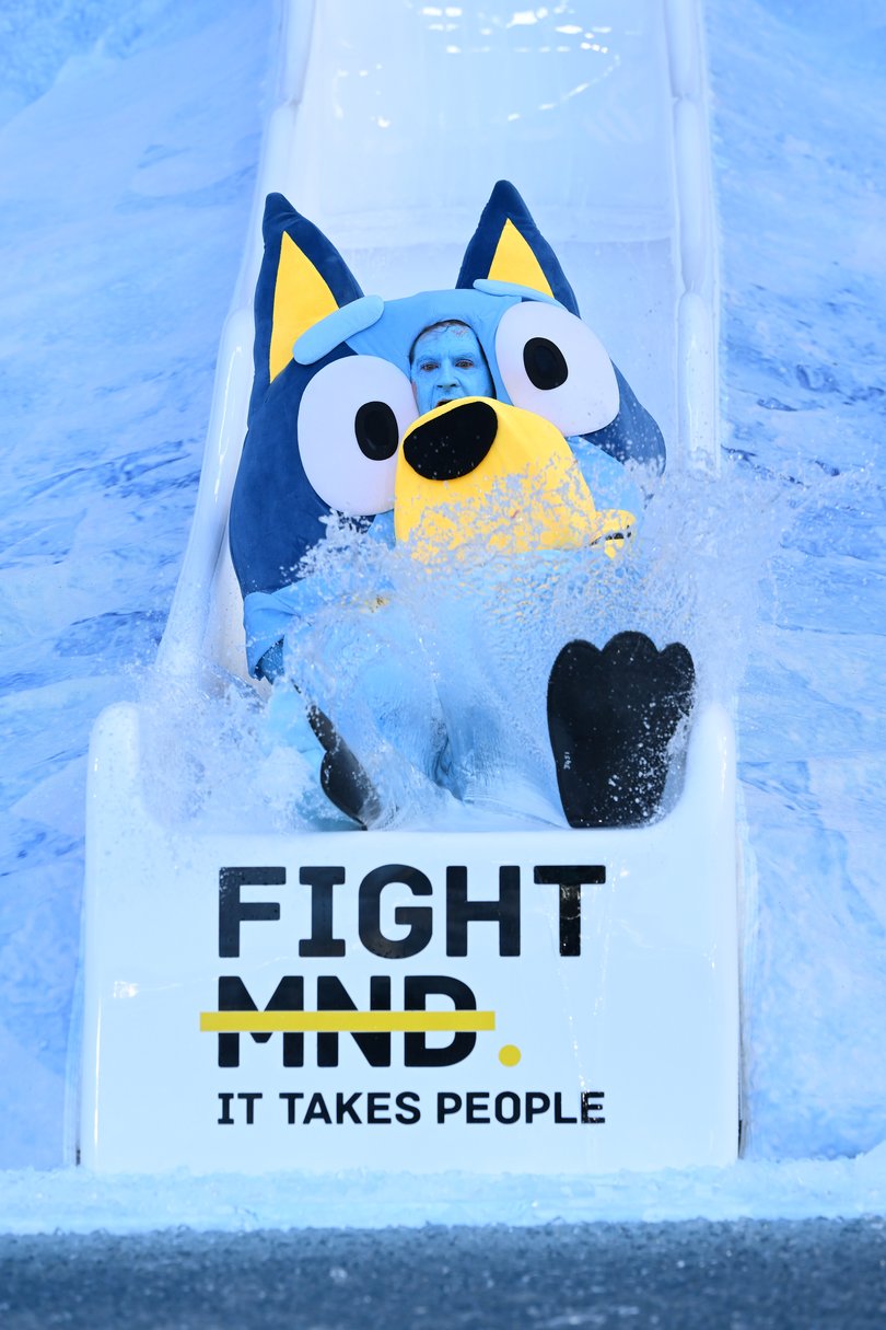 MELBOURNE, AUSTRALIA - JUNE 08: Sam Mac goes down the slide as Bluey for FightMND Big Freeze 12 ahead of the round 13 AFL match between Collingwood Magpies and Melbourne Demons at Melbourne Cricket Ground, on June 08, 2026, in Melbourne, Australia. (Photo by Quinn Rooney/Getty Images)