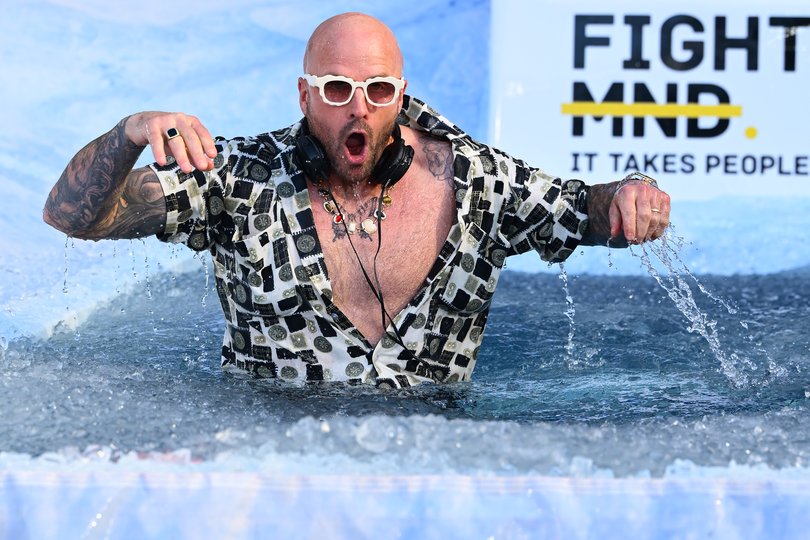 MELBOURNE, AUSTRALIA - JUNE 08: Nathan Jones goes down the slide as DJ Fisher for FightMND Big Freeze 12 ahead of the round 13 AFL match between Collingwood Magpies and Melbourne Demons at Melbourne Cricket Ground, on June 08, 2026, in Melbourne, Australia. (Photo by Quinn Rooney/Getty Images)