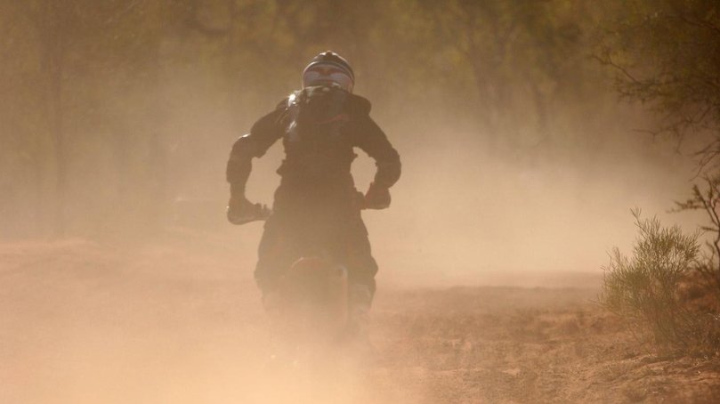 A motorcycle rider has died after crashing while competing in the off-road Finke Desert Race.