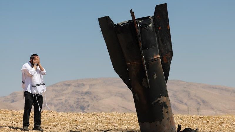 An Ultra-Orthodox Jew reacts to an Iranian missile that landed near a West Bank settlement.\