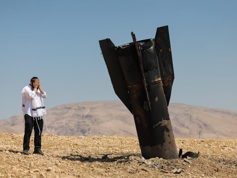 An Ultra-Orthodox Jew reacts to an Iranian missile that landed near a West Bank settlement.\