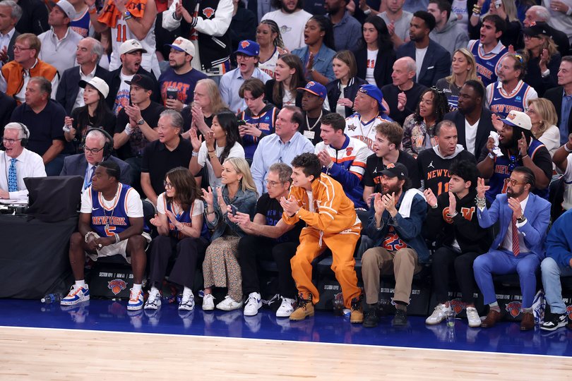 Actors Tracy Morgan, Tina Fey, Christine Taylor, Ben Stiller and Timothée Chalamet look on during the first quarter of Game 3.