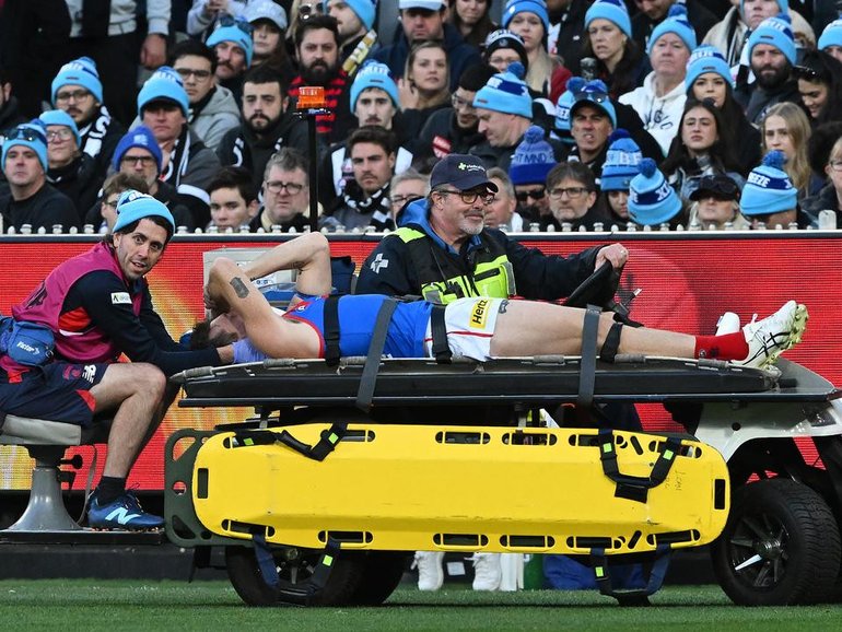 Brody Mihocek was stretchered off the MCG after fracturing his neck. (James Ross/AAP PHOTOS)