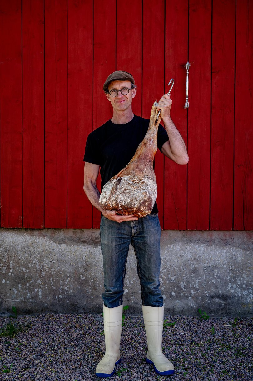 Lindegrens, an organic farm, butchery, charcuterie and restaurant near Bastad, Sweden; David Lindegren of Lindegren’s holds up a pork leg.