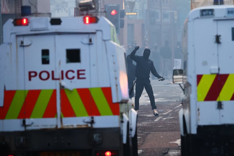 Police vehicles come under attack from protesters following a stabbing incident in Belfast, Tuesday, June 9, 2026. 