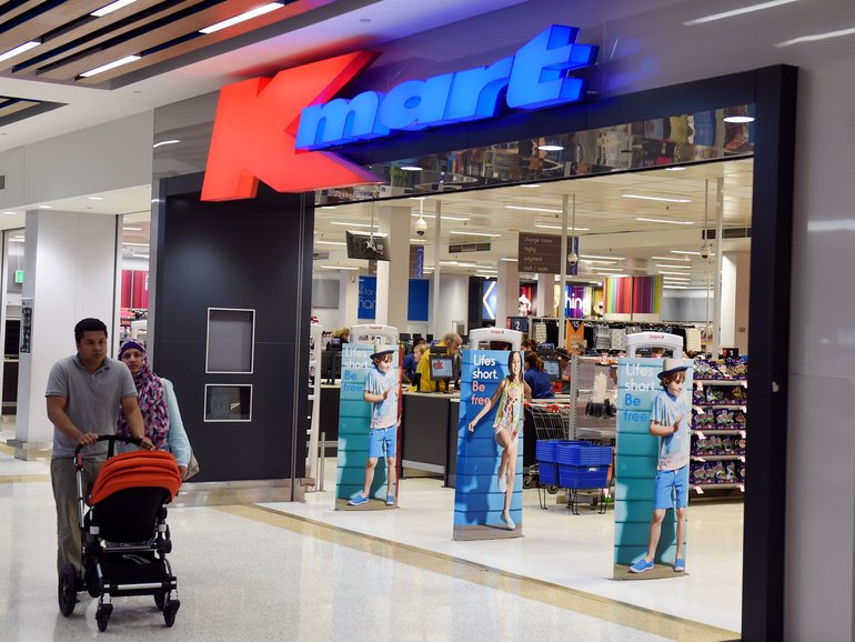Kmart is moving cash registers back to the store entrances.