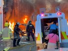 A family get into a  vehicle after being rescued from houses which caught fire in Lendrick Street in east Belfast, as disorder flared in response to Monday night's stabbing attack in the city. 