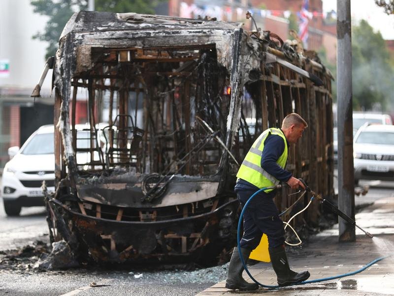 Belfast has woken to scenes of charred homes and cars after a night of anti-immigrant rioting.