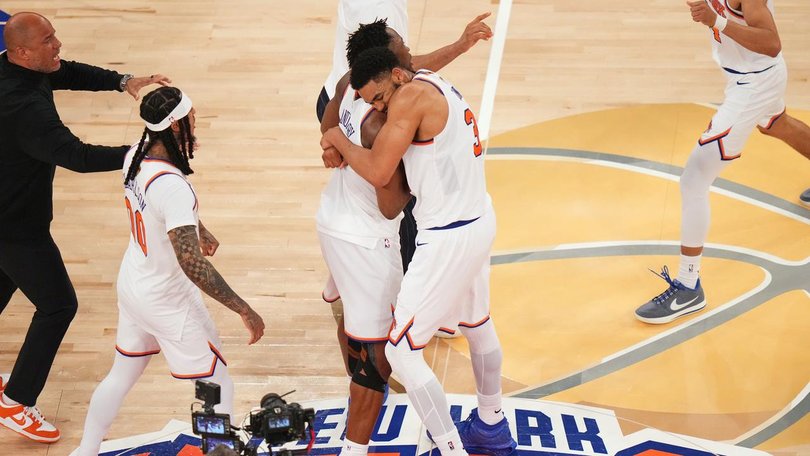 The Knicks celebrate their one-point win after staging a record comeback over the San Antonio Spurs. (AP PHOTO)