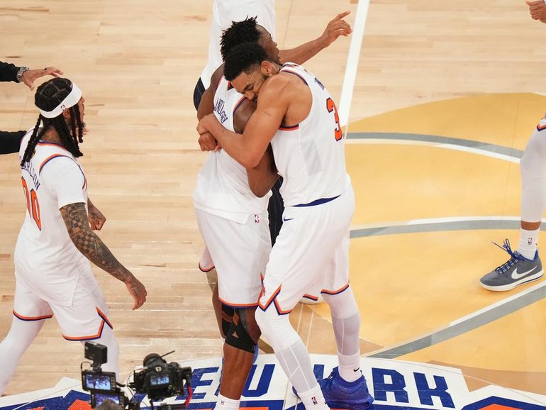 The Knicks celebrate their one-point win after staging a record comeback over the San Antonio Spurs. (AP PHOTO)
