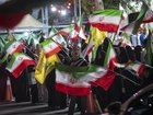 Pro-government supporters wave Iranian national flags as they participate in a nightly rally in northern Tehran, Iran, on June 8, 2026. 