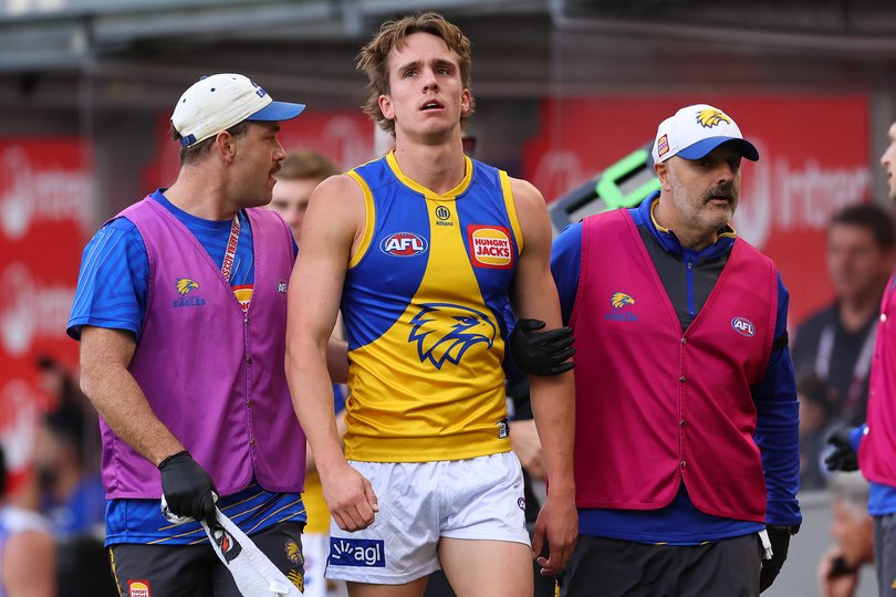 Hamish Davis of the Eagles comes from the field for a HIA test.