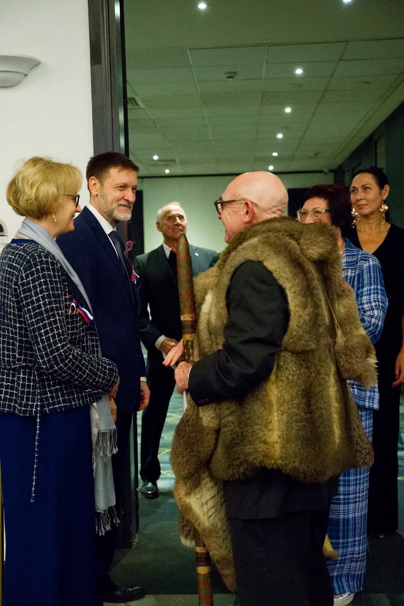 Mikhail Petrakov and his wife Irina greet an Indigenous elder.
