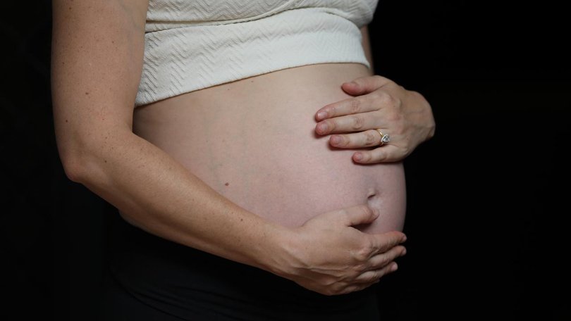 A coroner is probing the death of a woman who chose to give birth without any medical professionals.