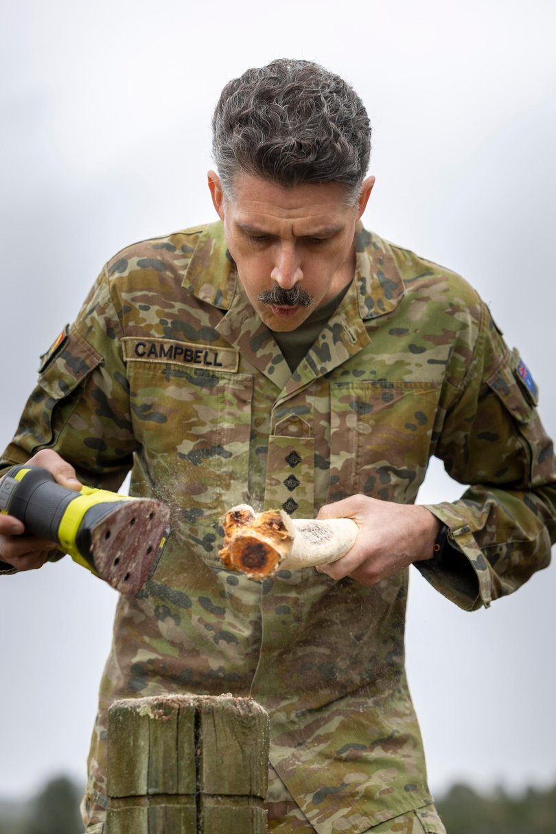 Captain Thomas Campbell from Queensland University Regiment prepares a Boondi during Exercise Greenskin in Canberra.