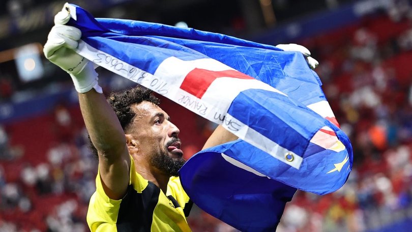 Cape Verde goalkeeper Vozinha, 40, celebrates with the national flag after keeping Spain at bay. (EPA PHOTO)