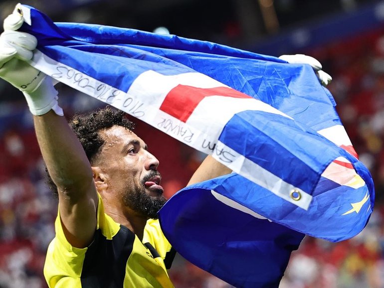 Cape Verde goalkeeper Vozinha, 40, celebrates with the national flag after keeping Spain at bay. (EPA PHOTO)