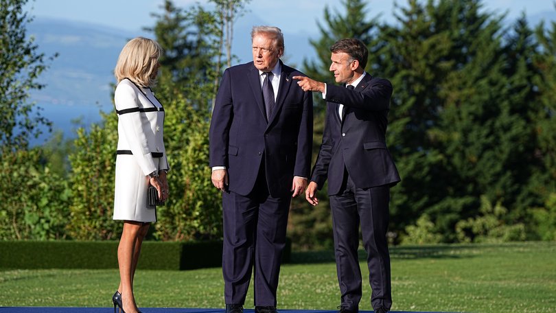 President Donald Trump, center, during a welcome ceremony hosted by President Emmanuel Macron of France, right, and his wife, Brigitte Macron, at the G7 Summit in Evian-les-Bains, France.
