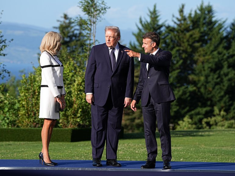 President Donald Trump, center, during a welcome ceremony hosted by President Emmanuel Macron of France, right, and his wife, Brigitte Macron, at the G7 Summit in Evian-les-Bains, France.