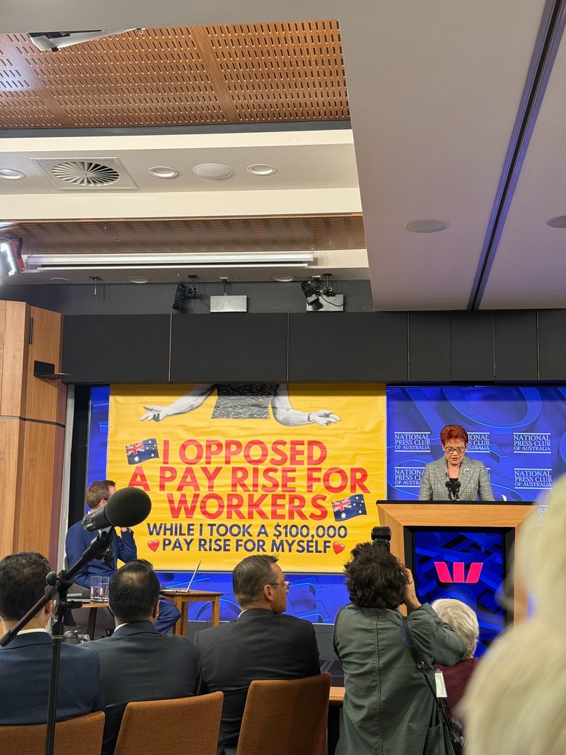 The poster that unfurled at the National Press Club.