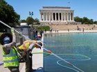Workers are trying to clean green algae from Washington's Lincoln Memorial Reflecting Pool. 