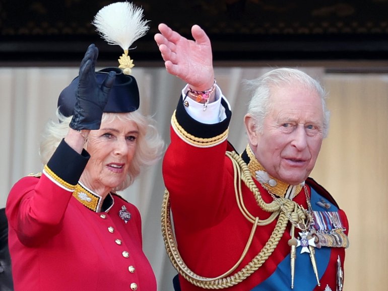 Charles pictured wearing two friendship bracelets under his traditional red uniform.