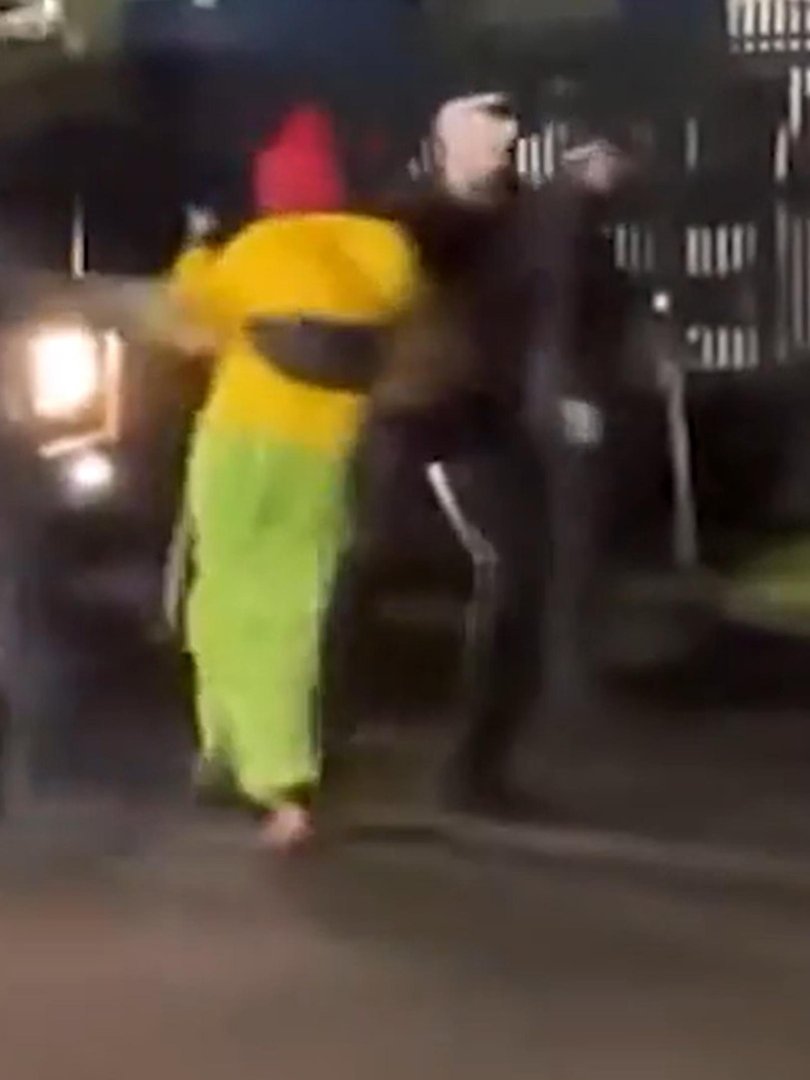 The officer grabs the woman by her right arm and swings her towards the sidewalk. Picture: Supplied