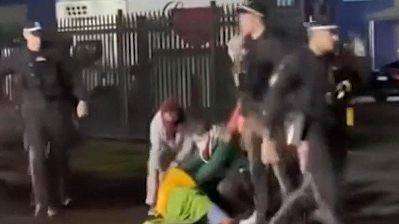 The officer walks away as the woman lies immobile on the street. Picture: Supplied