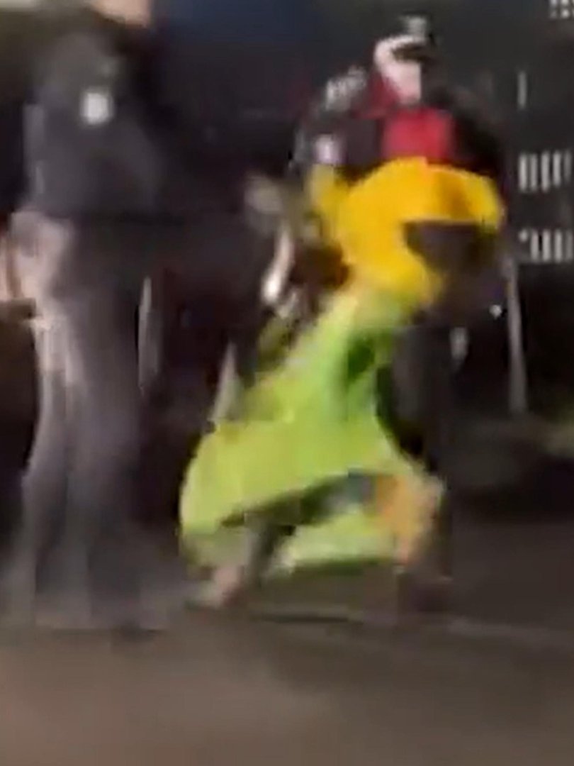 The woman is flung to the side as the officer stumbles. Picture: supplied