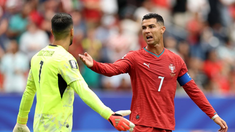 Cristiano Ronaldo #7 of Portugal reacts with Diogo Costa #1 after conceding an equalizer.