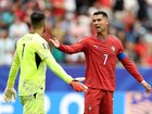 Cristiano Ronaldo #7 of Portugal reacts with Diogo Costa #1 after conceding an equalizer.