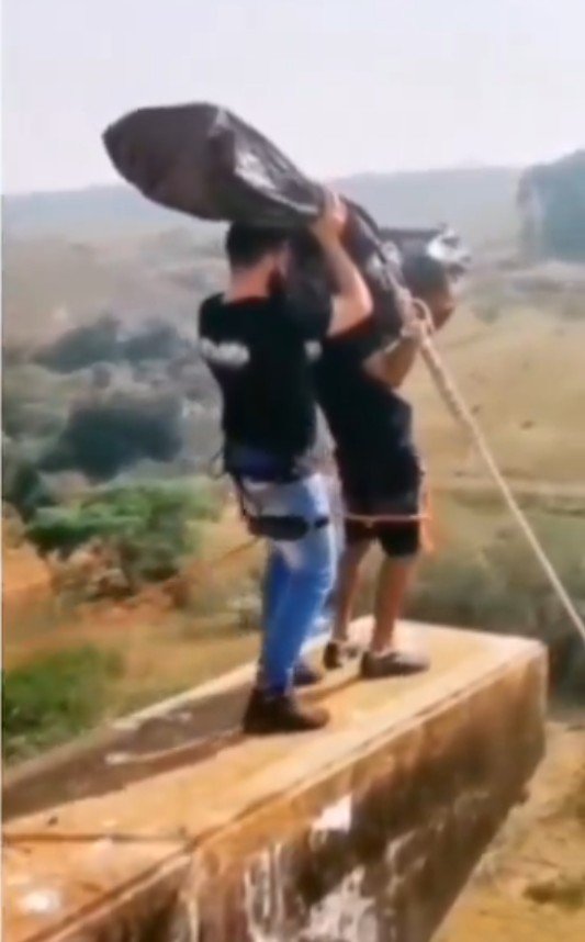 A 'body bag' is thrown off the bridge.