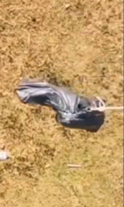 A 'body bag' is thrown off a bridge
