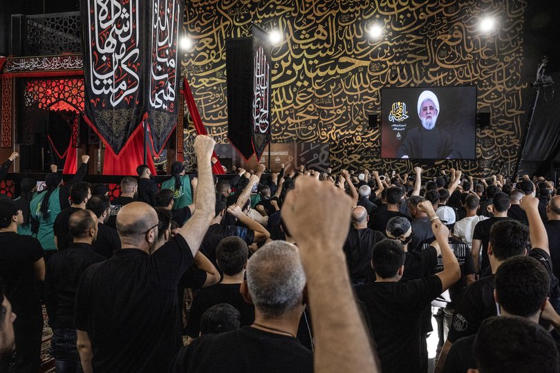 People chant the name of Hezbollah leader Sheikh Naim Kassem in Beirut, Lebanon, on Wednesday.
