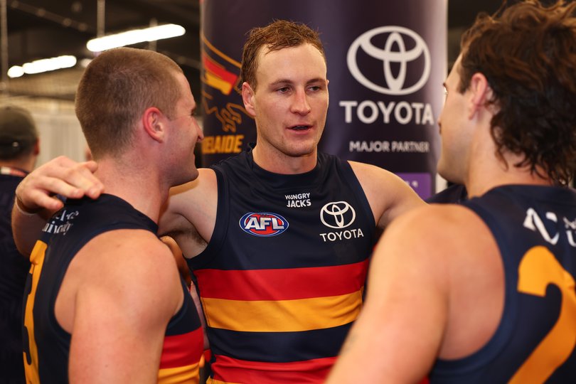 Jordan Dawson of the Crows celebrates with Sam Berry and James Peatling.