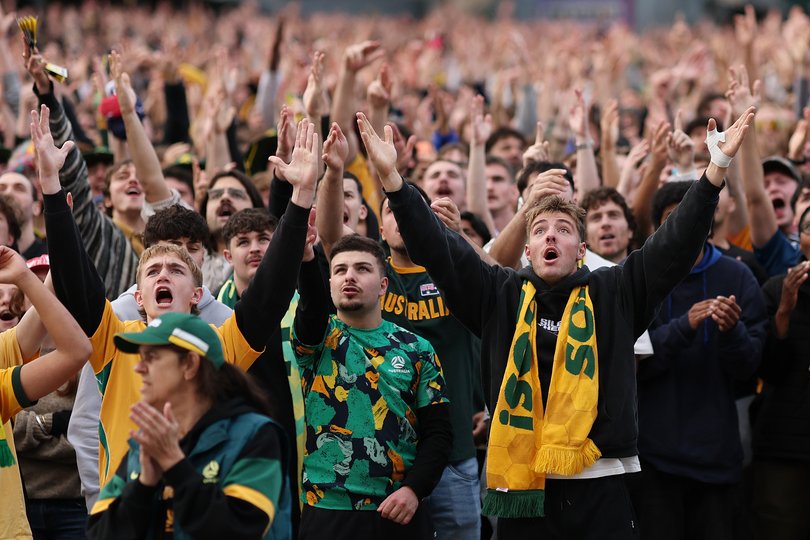 Fans watch the FIFA World Cup match between the Socceroos and Türkiye on the big screen.