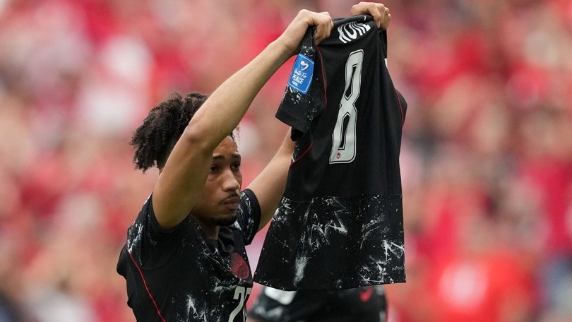 Nathan Saliba celebrates his World Cup goal by holding up Kone’s jersey.