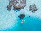 White sandbanks and turquoise lagoons create the postcard-perfect side of Aitutaki.