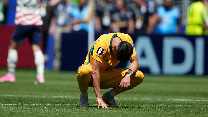 Wayne Rooney says the Socceroos were 'awful' in the opening half of their clash with the US. (AP PHOTO)